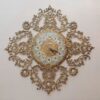 Luxurious Brass Wall Clock Featuring a Delicate Floral Accent